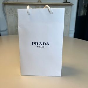 Empty white Prada shopping bag